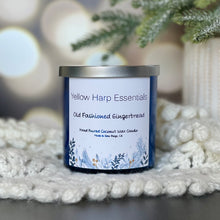 Load image into Gallery viewer, Yellow harp essentials highly scented coconut wax candle with crackling wood wick in old-fashioned gingerbread scent. Glass blue jar with silver metal lid. ￼
