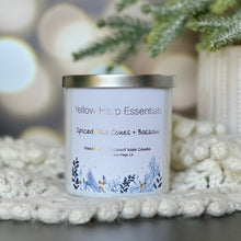 Load image into Gallery viewer, Yellow harp essentials hand poured coconut wax candle with crackling wood wick, and highly scented spiced pinecones and balsam fragrance. White glass jar with silver metal lid. ￼
