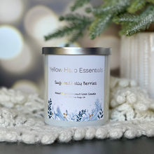 Load image into Gallery viewer, Yellow harp essentials hand poured coconut wax candle with crackling wood wick, and highly scented sugared Holly berries scent. White glass jar with silver metal lid. ￼
