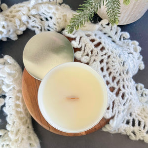 Top view, yellow harp essentials coconut wax candle with crackling wood wick and white glass jar with silver metal lid. ￼