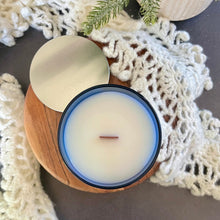 Load image into Gallery viewer, Top view of yellow harp essentials highly scented old-fashioned gingerbread candle in glass blue jar with silver metal lid. ￼
