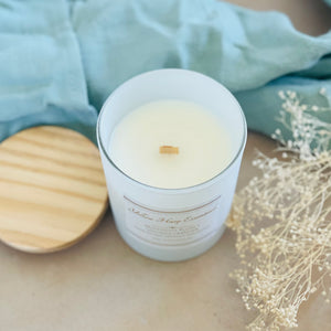 highly scented coconut wax candle with crackling wood wick midnight plum and vintage leather scent white glass reusable jar wooden lid